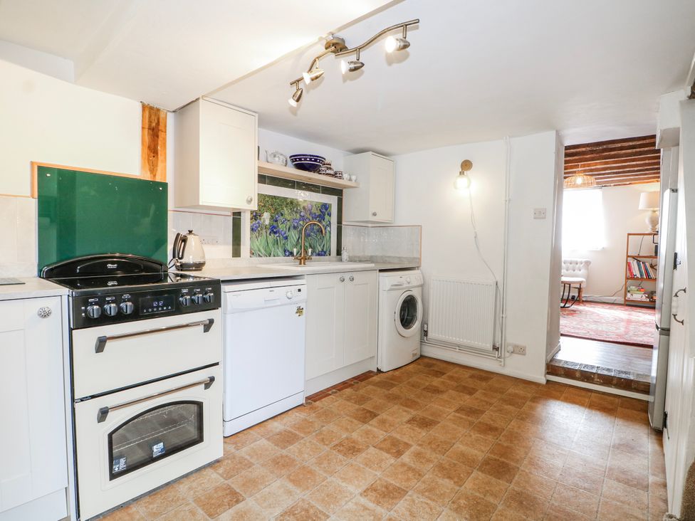 A kitchen with appliances and cabinets at 7 Chapel Hill Quinc Cottage Lewes