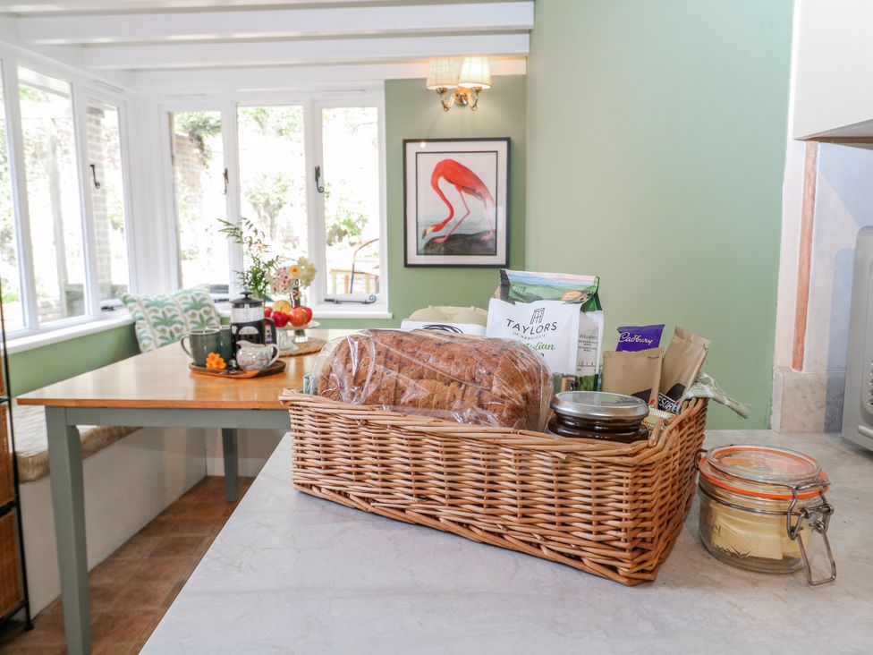 A kitchen with a basket of bread and a coffee maker at 7 Chapel Hill Quinc Cottage Lewes