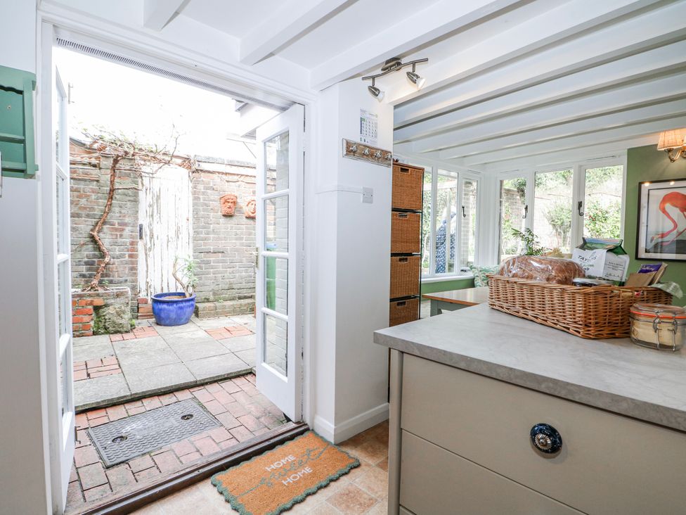 A kitchen leading to a garden at 7 Chapel Hill Quinc Cottage in Lewes