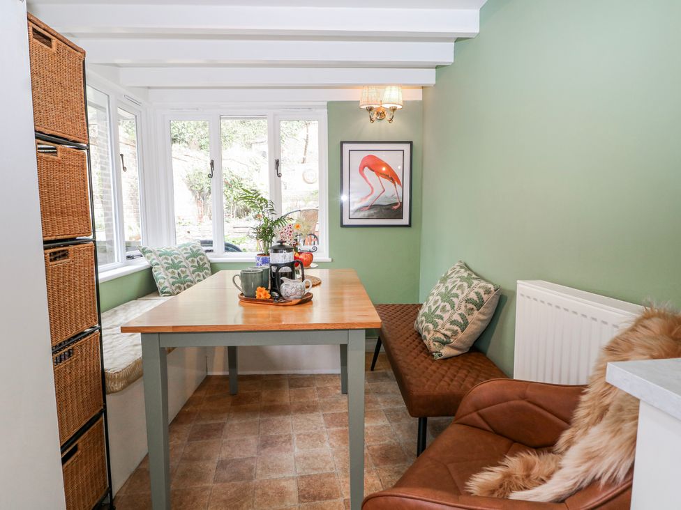 A dining room with a table and chairs at 7 Chapel Hill Quinc Cottage Lewes