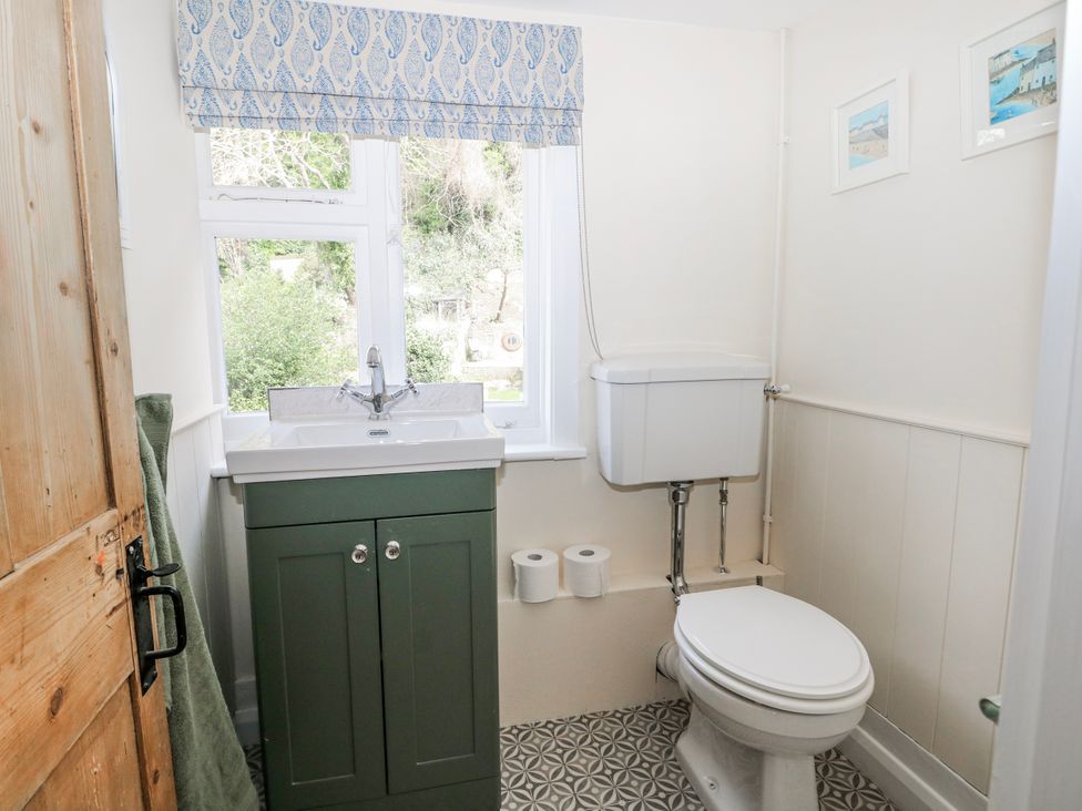 A bathroom with a sink and toilet at 7 Chapel Hill Quinc Cottage in Lewes