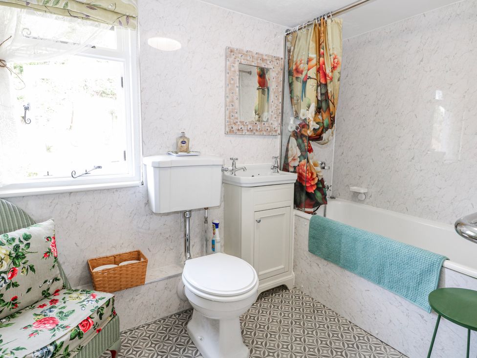 A bathroom with a toilet, sink, and bathtub at 7 Chapel Hill Quinc Cottage Lewes