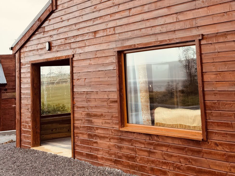 A wooden exterior wall with a window and door at Fisherman Lodge No 2 Enniskillen