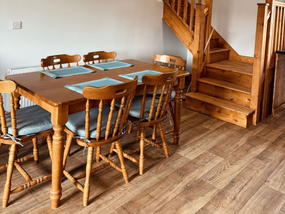 A dining room with a wooden table and chairs at Fisherman Lodge No 2 Enniskillen