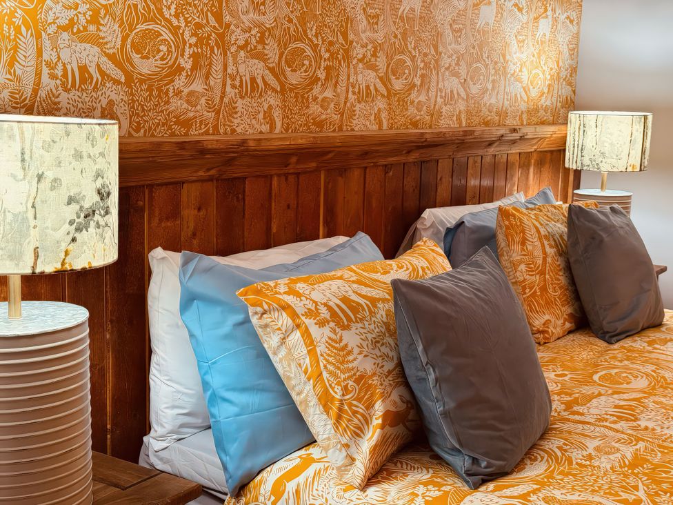 A bedroom with a bed and decorative pillows at Fisherman Lodge No 2 Enniskillen