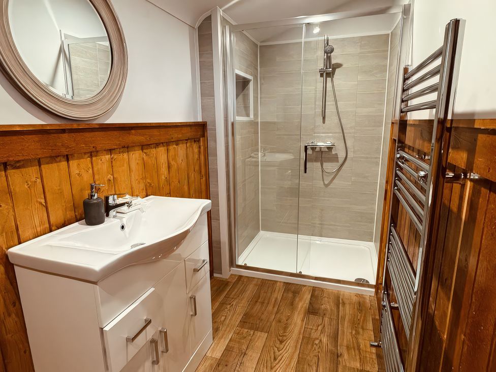 A bathroom with a sink and shower at Fisherman Lodge No 2 Enniskillen