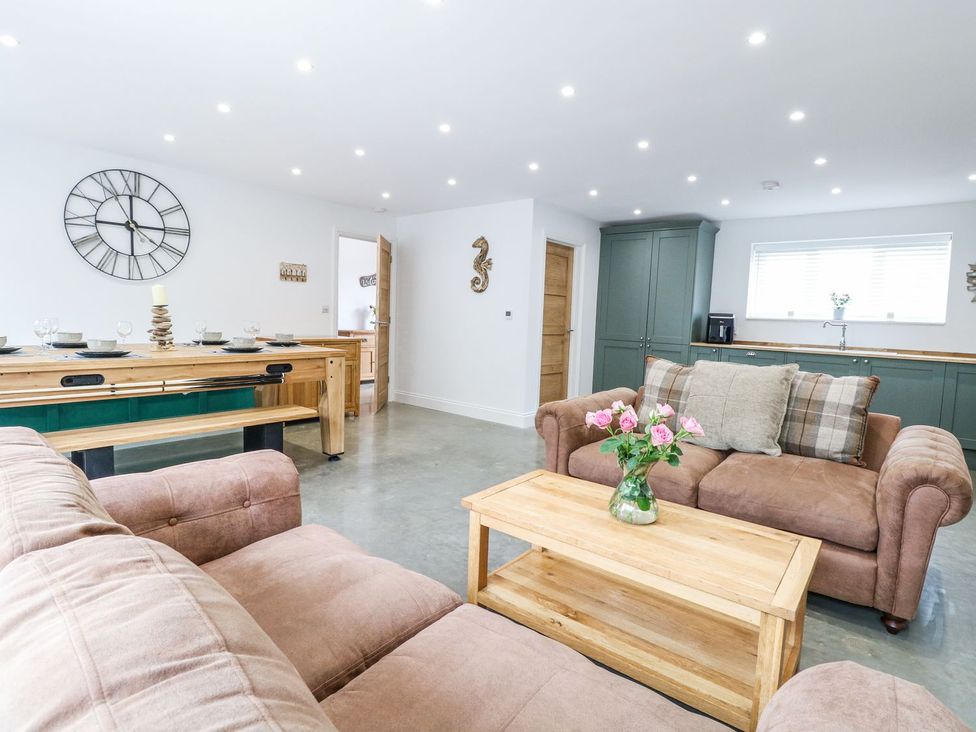 A living room with a sofa and dining table at The Ivy in Norwich