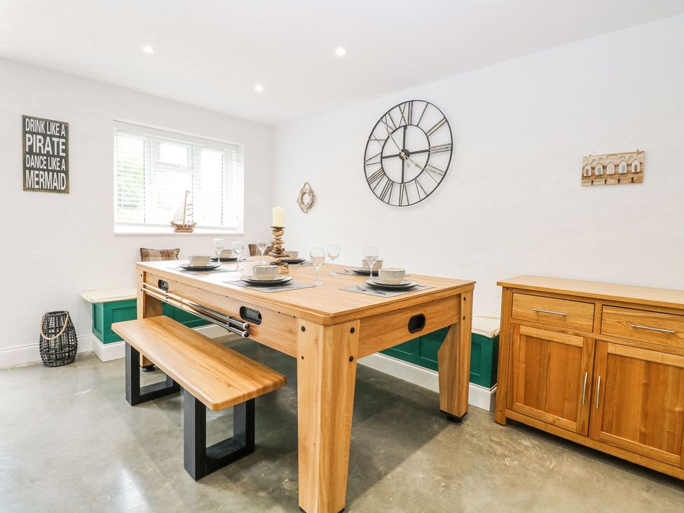 A dining room with a table and benches at The Ivy in Norwich