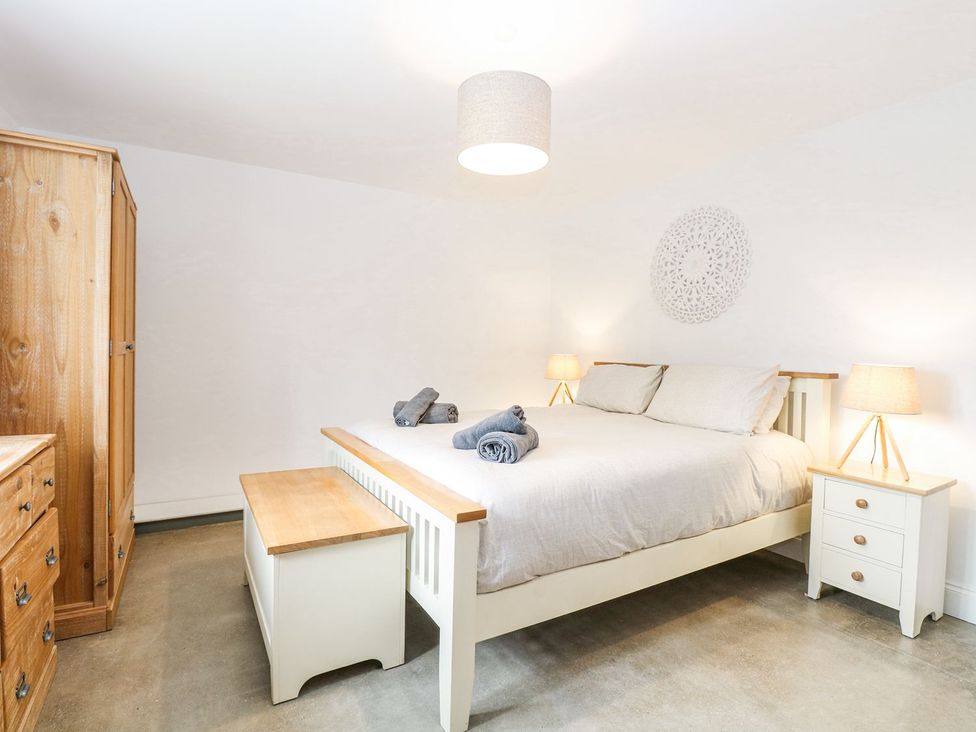 A bedroom with a bed and wardrobe at The Ivy in Norwich