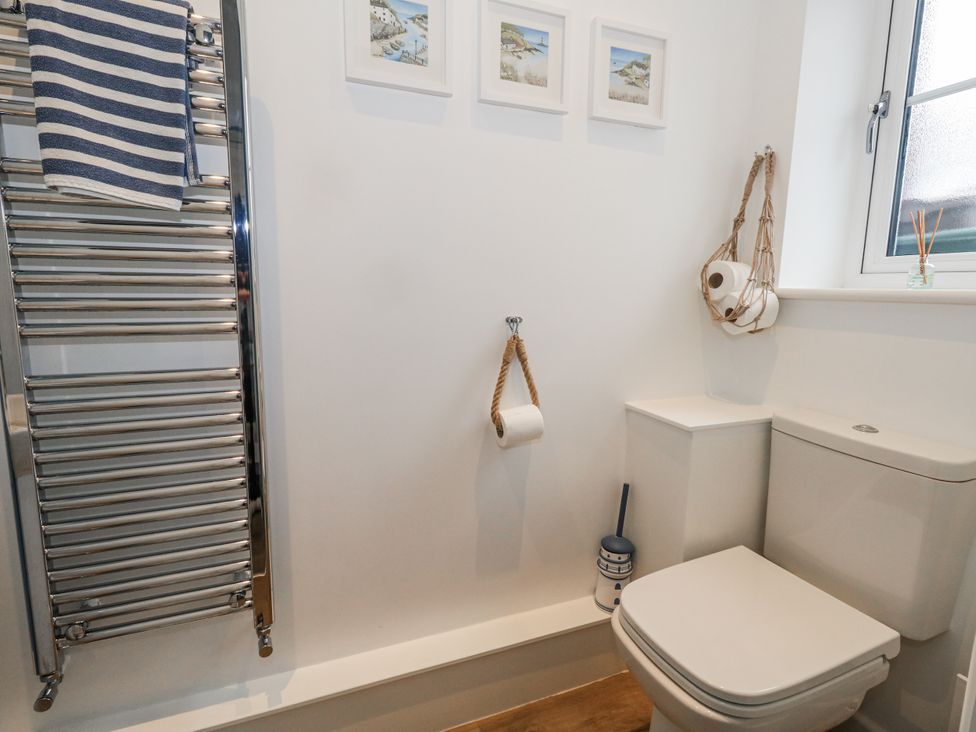 A bathroom featuring a towel rail and a toilet at 8 Park View Grove in Weymouth