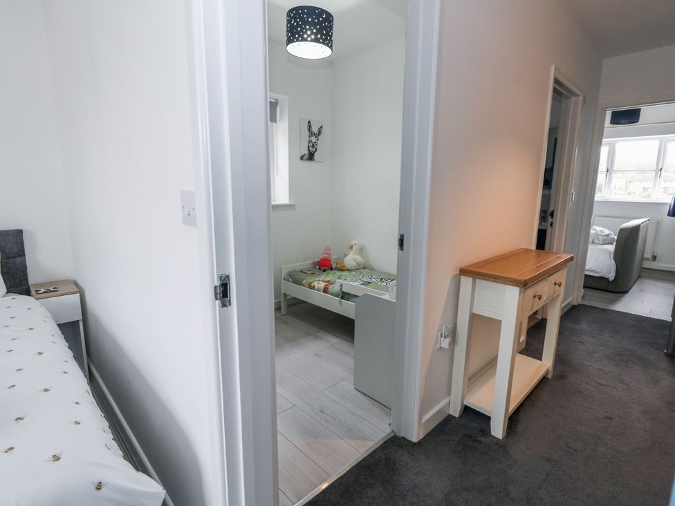 A bedroom with a bed and children toys at 8 Park View Grove in Weymouth