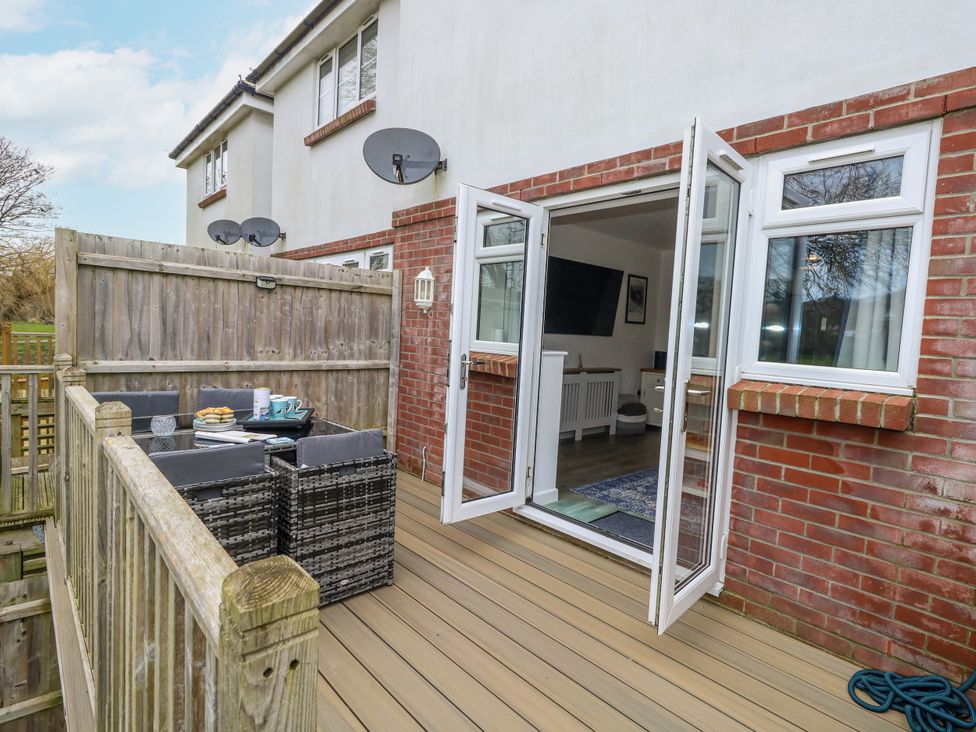 An outdoor area with furniture and a view of the interior at 8 Park View Grove in Weymouth