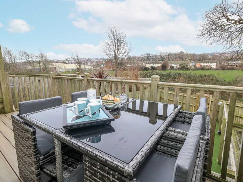 An outdoor seating area with table and chairs at 8 Park View Grove Weymouth