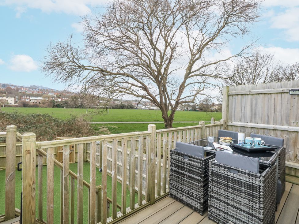 An outdoor area with a table and chairs at 8 Park View Grove in Weymouth
