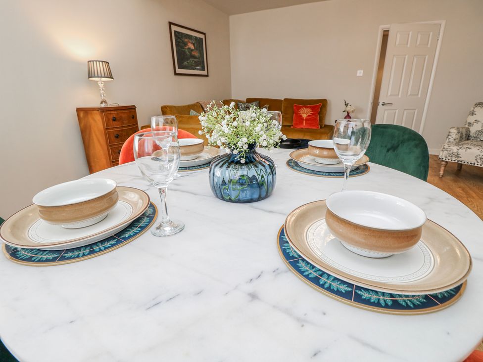 A dining room table set with plates and glasses at 1A Clifton Road in Winchester