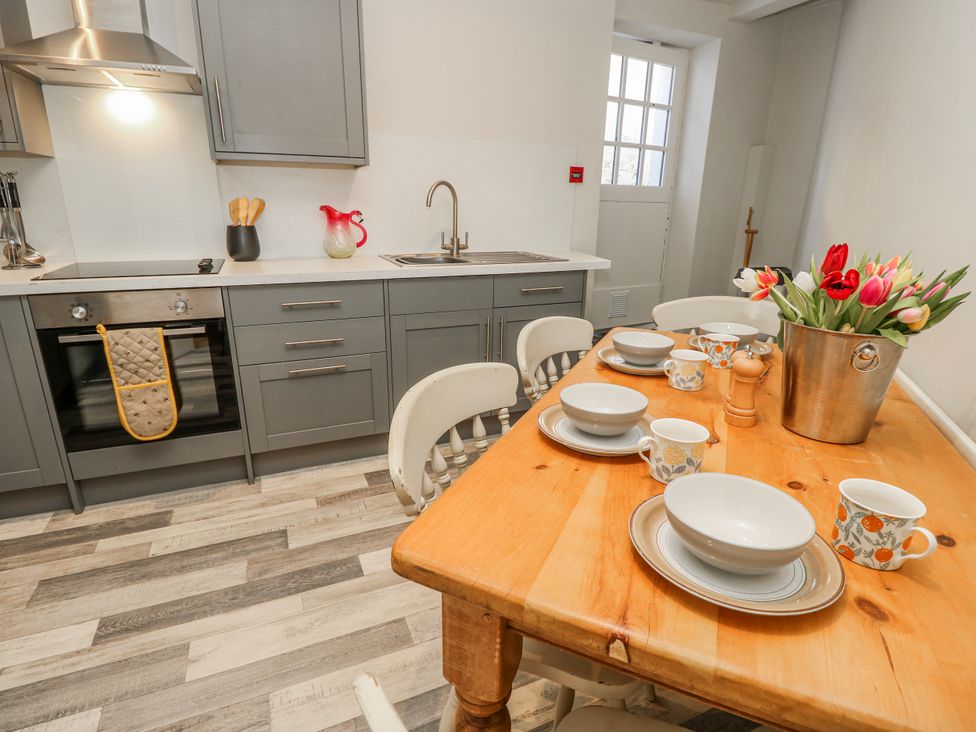A kitchen with a dining table set for meals at 1A Clifton Road in Winchester