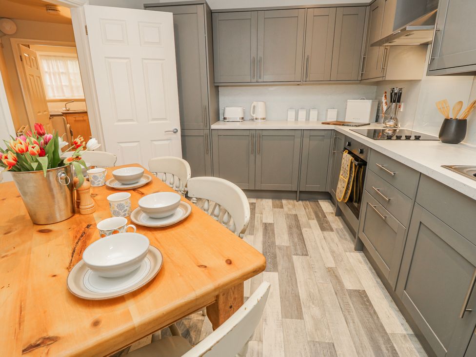 A kitchen with a dining table and appliances at 1A Clifton Road Winchester