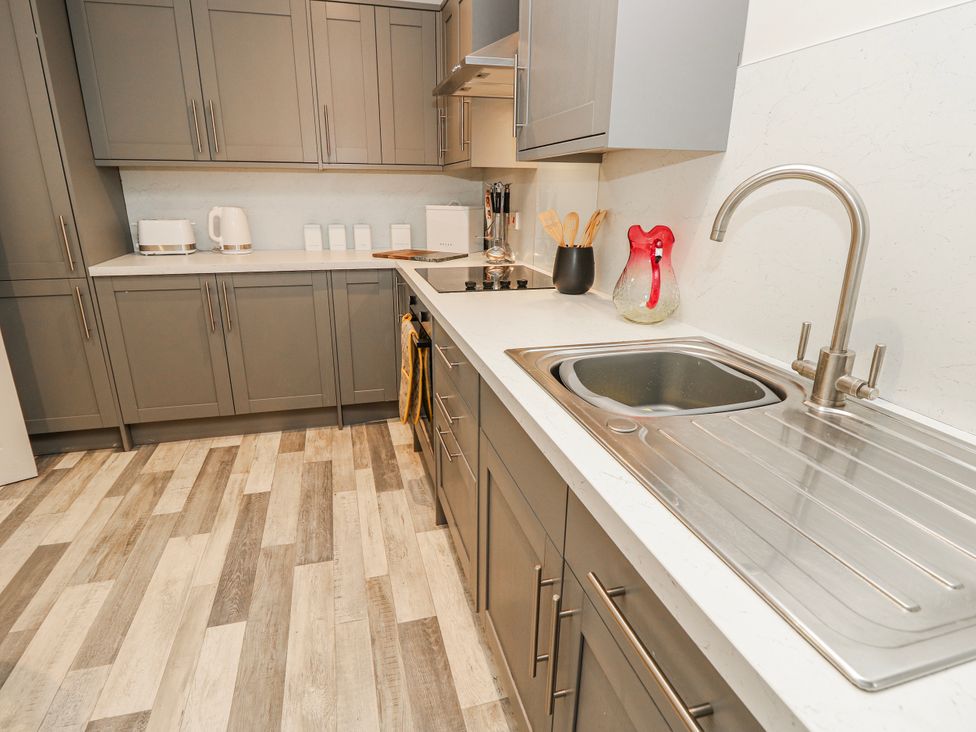 A kitchen with cabinets and sink at 1A Clifton Road in Winchester