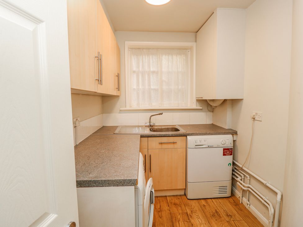 A kitchen with a sink and appliances at 1A Clifton Road in Winchester