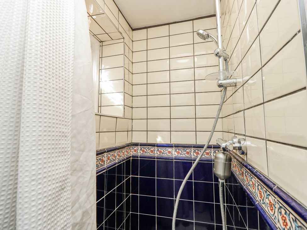 A shower with tiled walls at 1A Clifton Road in Winchester
