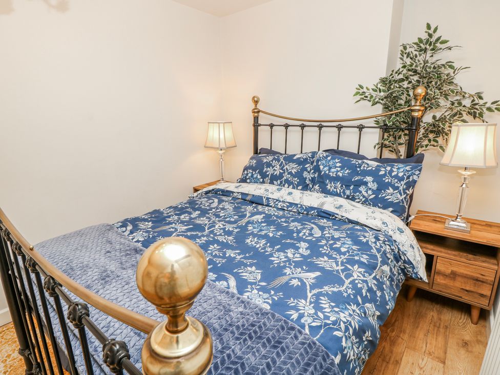 A bedroom with a bed and bedside table at 1A Clifton Road in Winchester