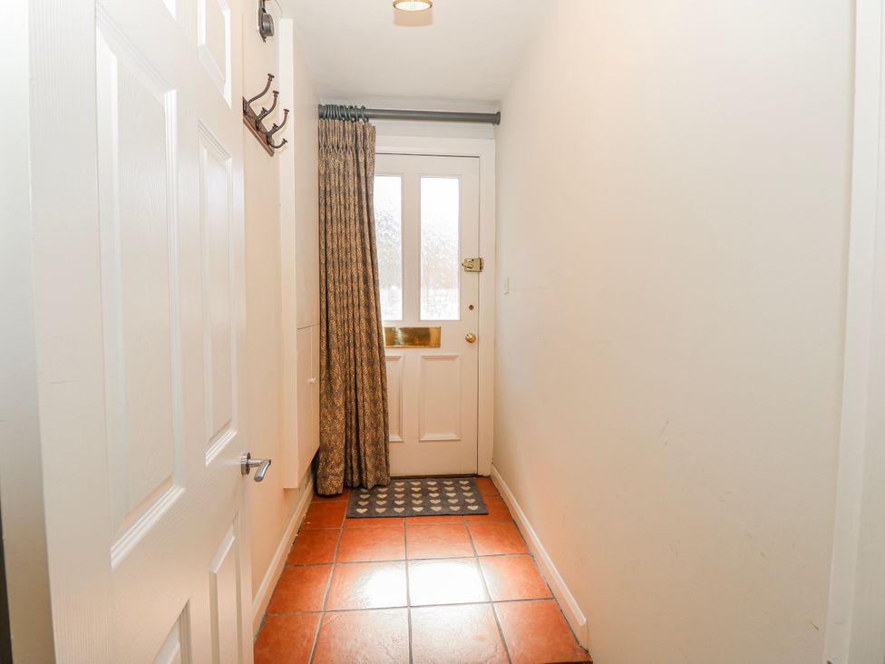 A hallway with hooks and a front door at 1A Clifton Road in Winchester