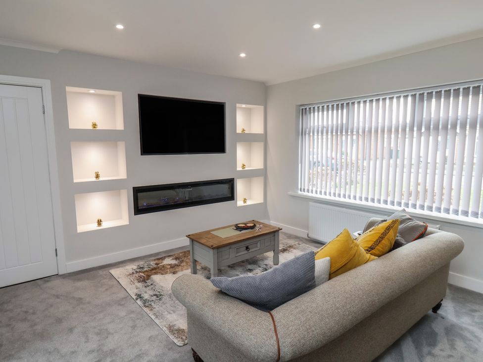 A living room with a sofa and television at Sea View House in Marske-By-The-Sea