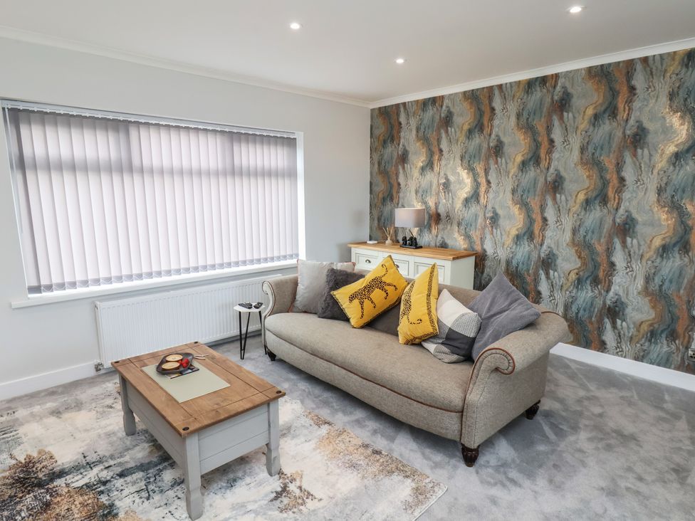 A living room with a sofa and coffee table at Sea View House in Marske-By-The-Sea