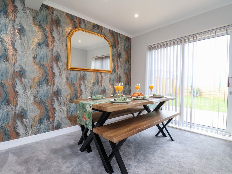 A dining room with a table set for a meal at Sea View House in Marske-By-The-Sea