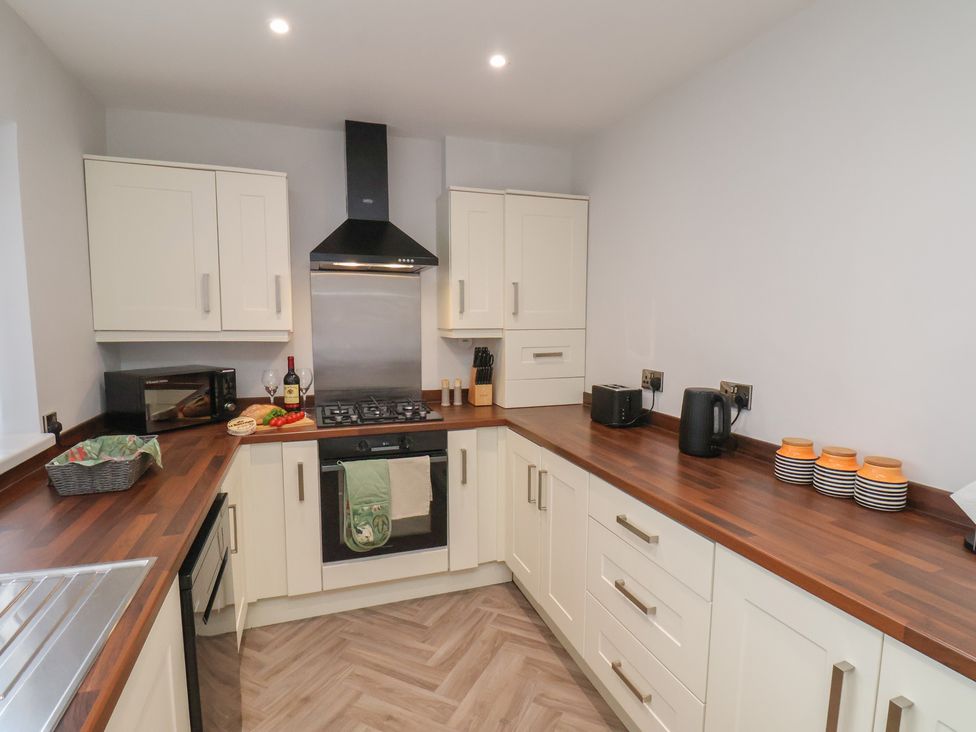 A kitchen with cabinets and appliances at Sea View House in Marske-By-The-Sea