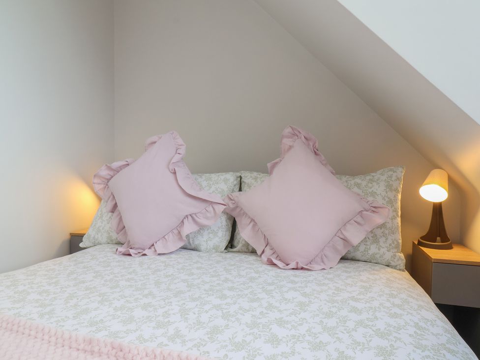 A bedroom with a bed and pillows at Sea View House in Marske-By-The-Sea