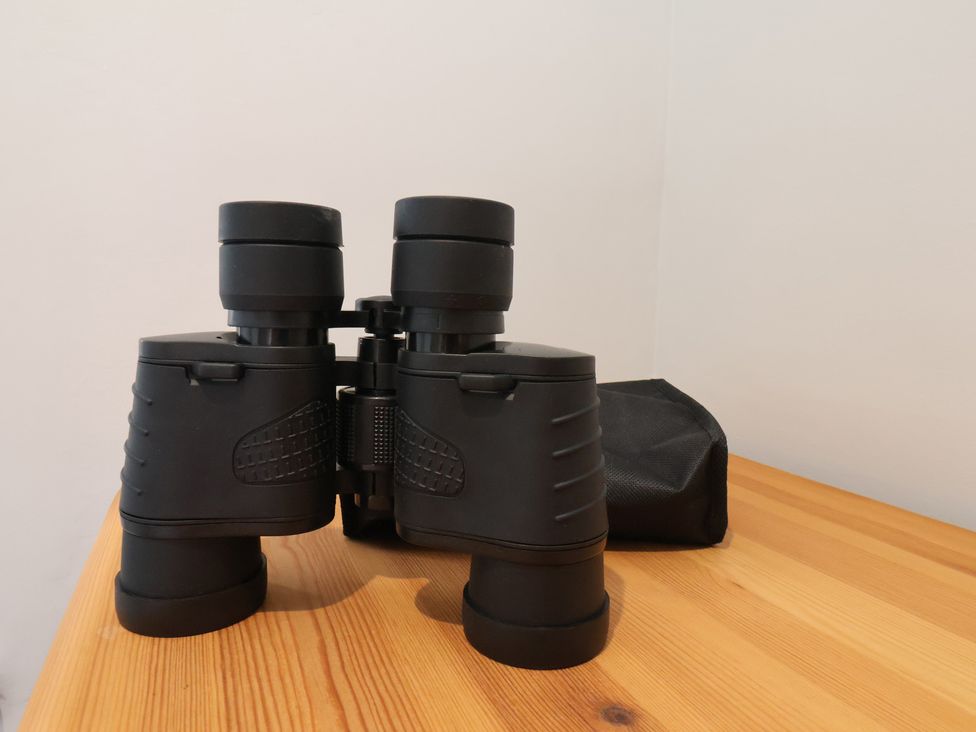 A set of binoculars on a wooden table at Sea View House Marske-By-The-Sea