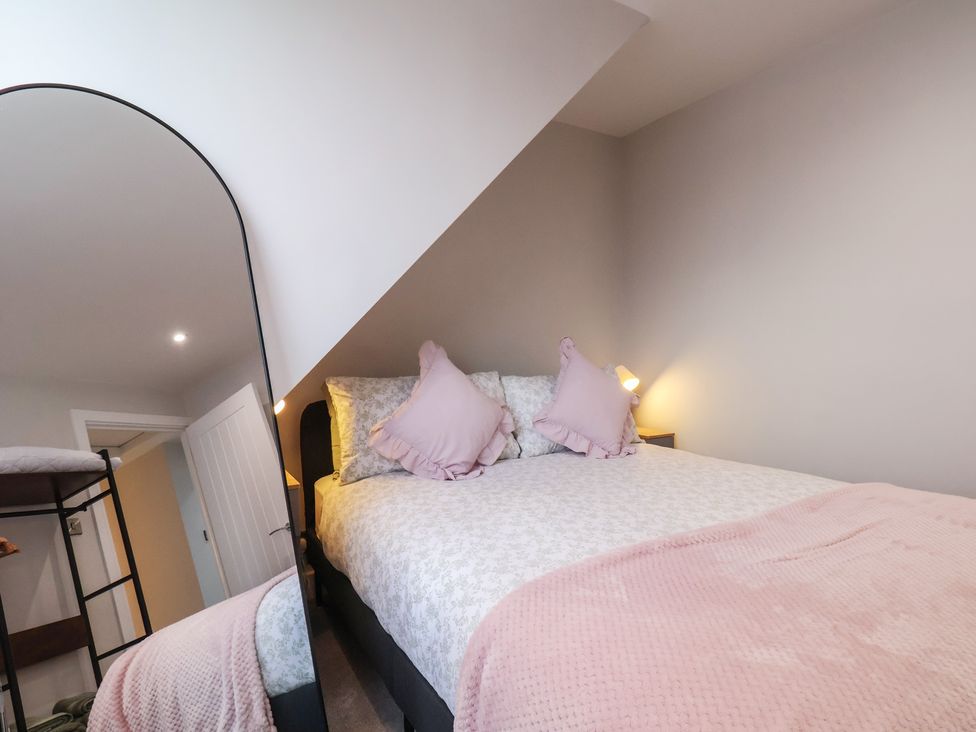 A bedroom with a bed and a bunk bed at Sea View House in Marske-By-The-Sea