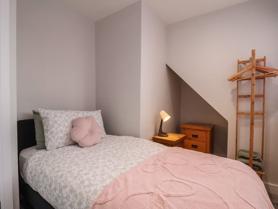 A bedroom with a bed and a lamp at Sea View House in Marske-By-The-Sea