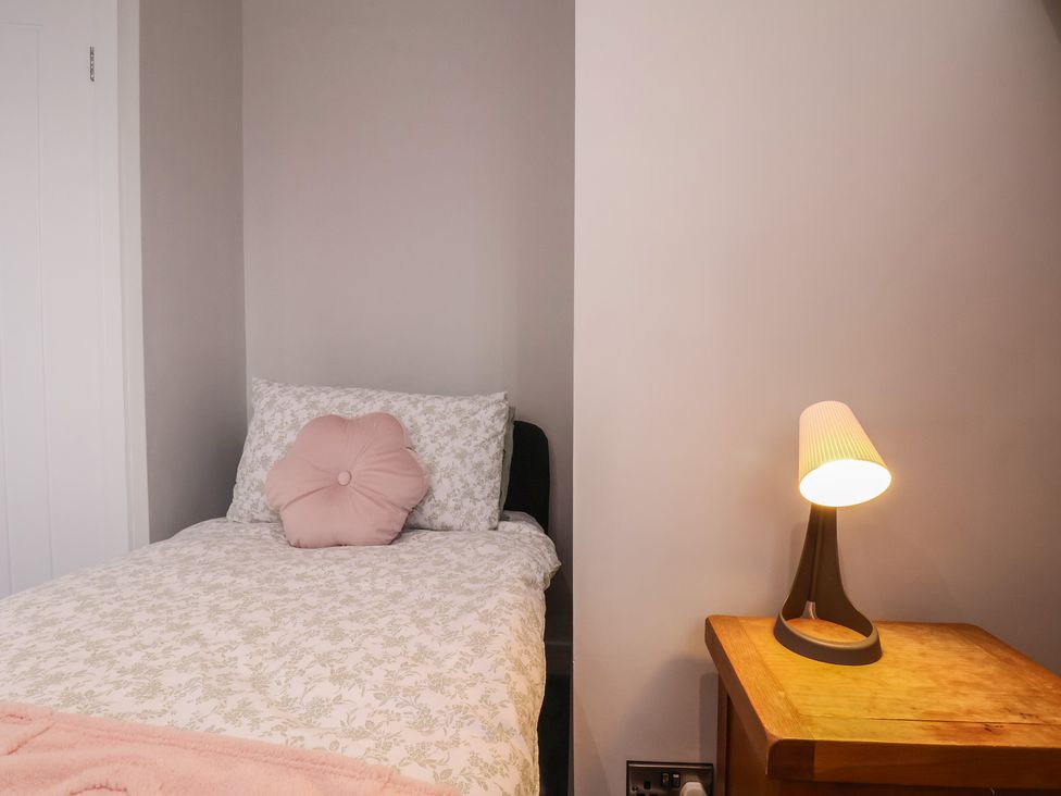 A bedroom with a bed and a lamp at Sea View House in Marske-By-The-Sea