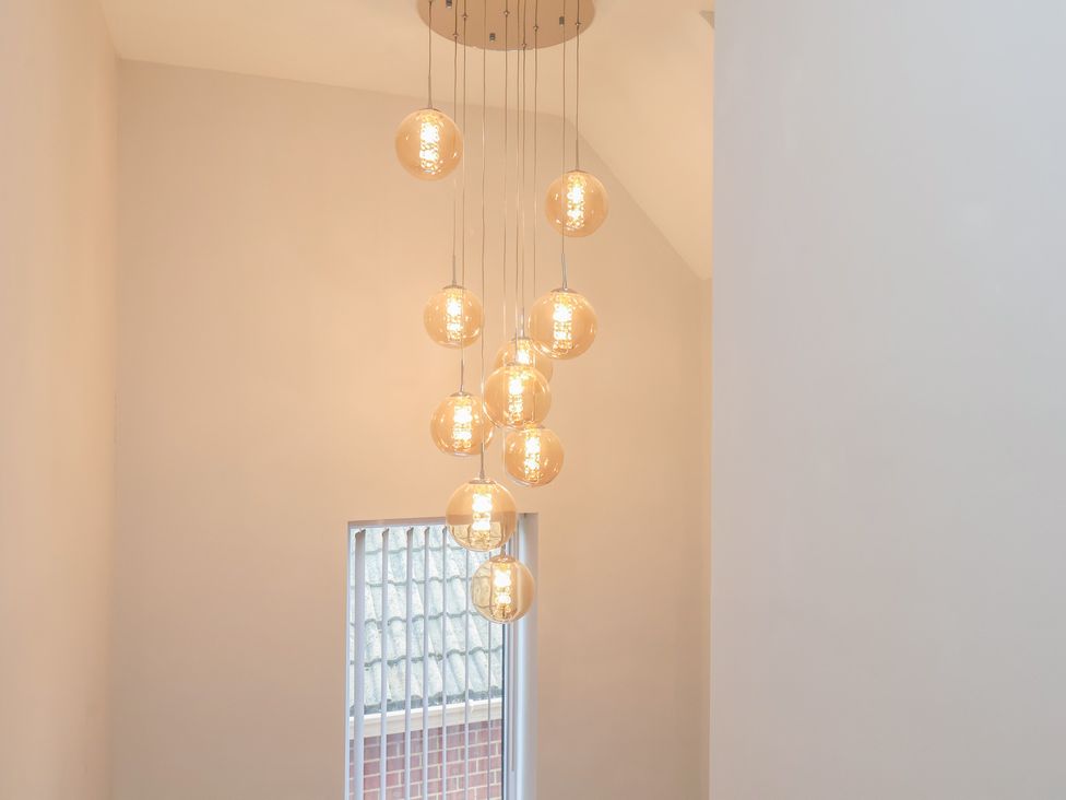 A staircase with pendant lighting at Sea View House in Marske-By-The-Sea