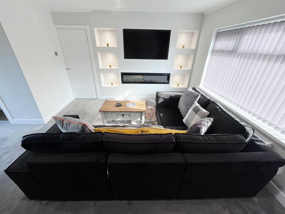 A living room with a sofa and coffee table at Sea View House in Marske-By-The-Sea