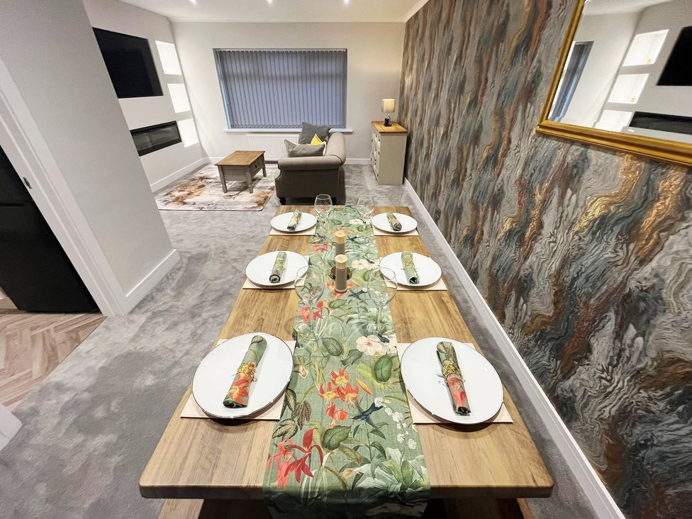 A dining room with a table set for dinner at Sea View House in Marske-By-The-Sea