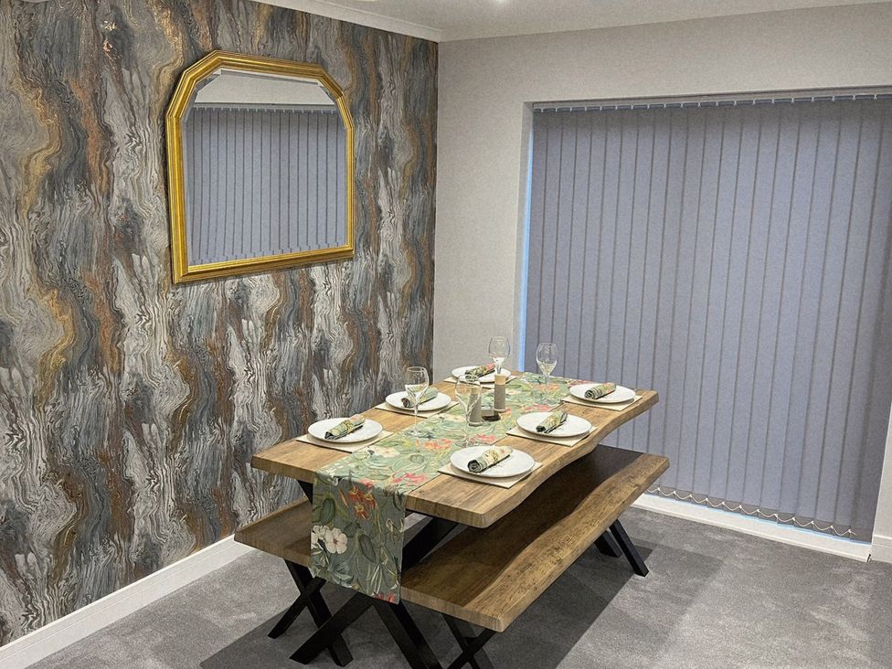 A dining room with a table set for dinner at Sea View House in Marske-By-The-Sea