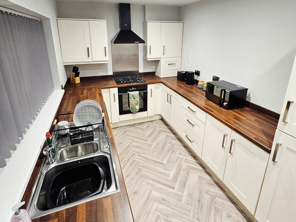 A kitchen with a sink and gas stove at Sea View House Marske-By-The-Sea