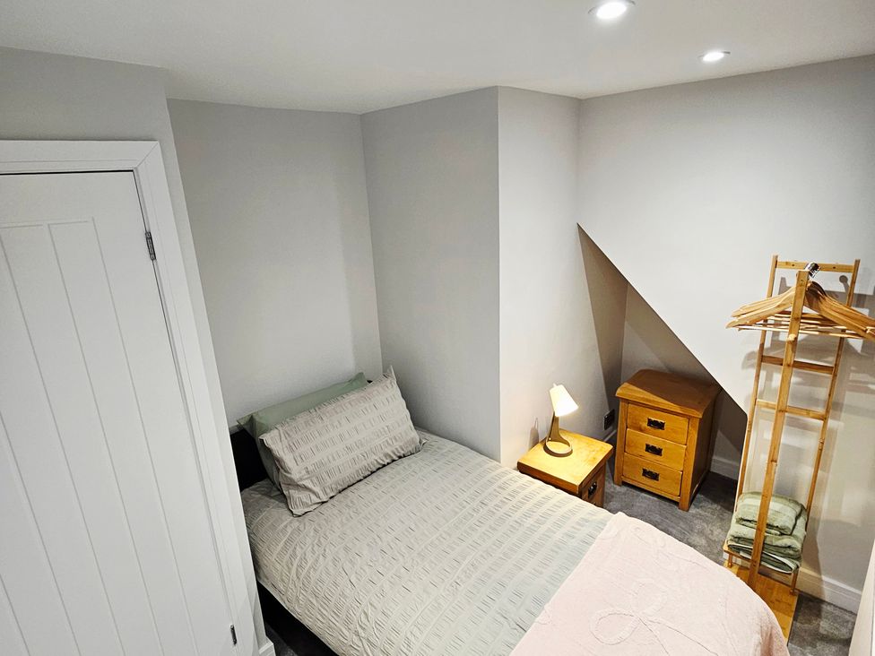 A bedroom with a bed and lamp at Sea View House in Marske-By-The-Sea