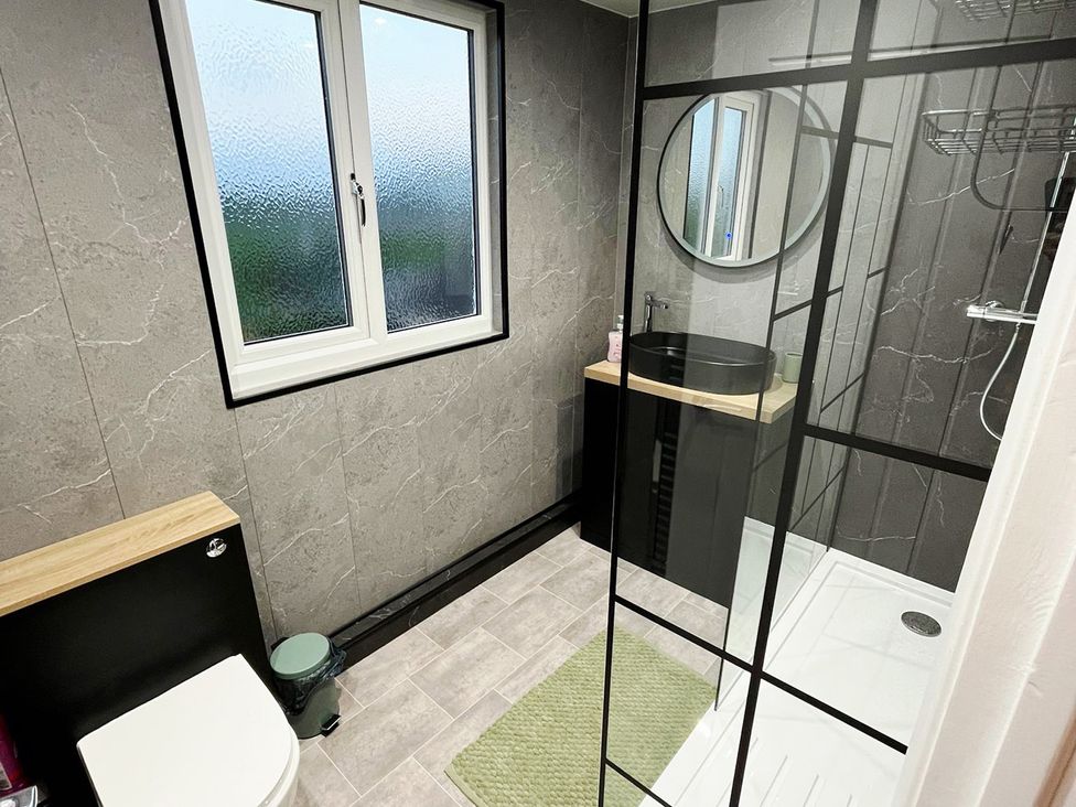 A bathroom with a shower and sink at Sea View House in Marske-By-The-Sea