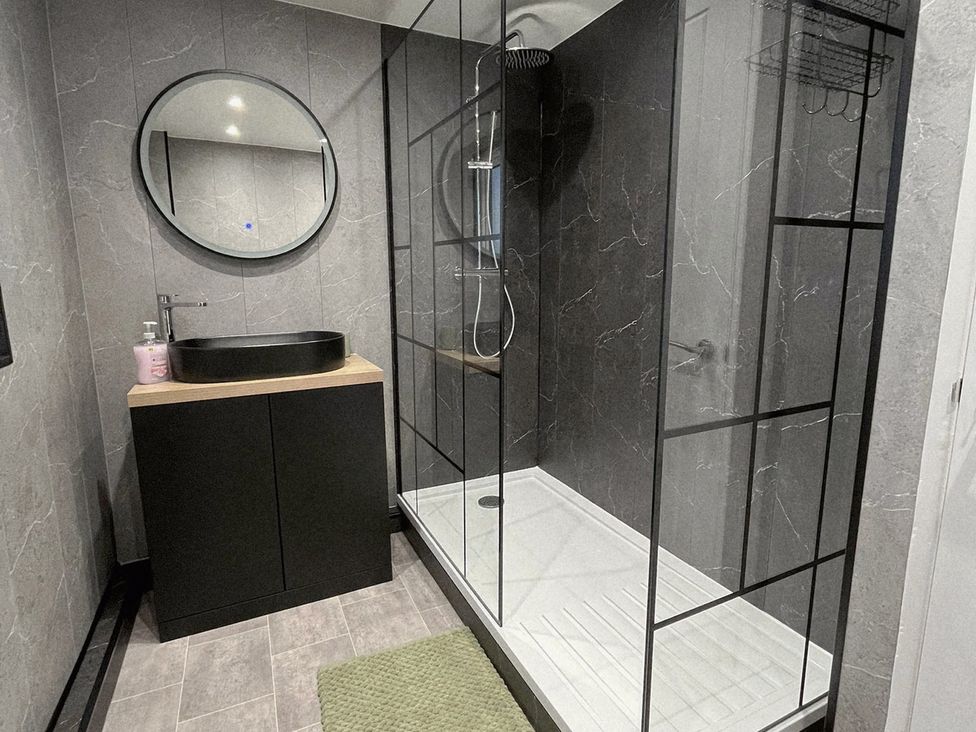 A bathroom with a shower and sink at Sea View House in Marske-By-The-Sea