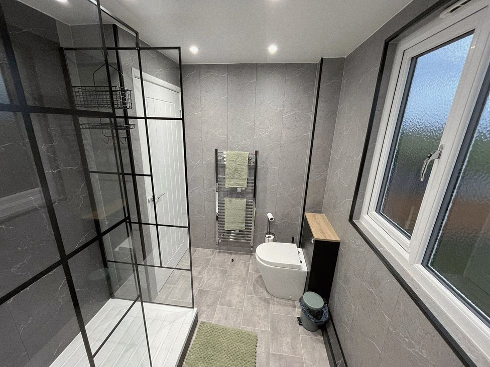 A bathroom with a shower and toilet at Sea View House in Marske-By-The-Sea