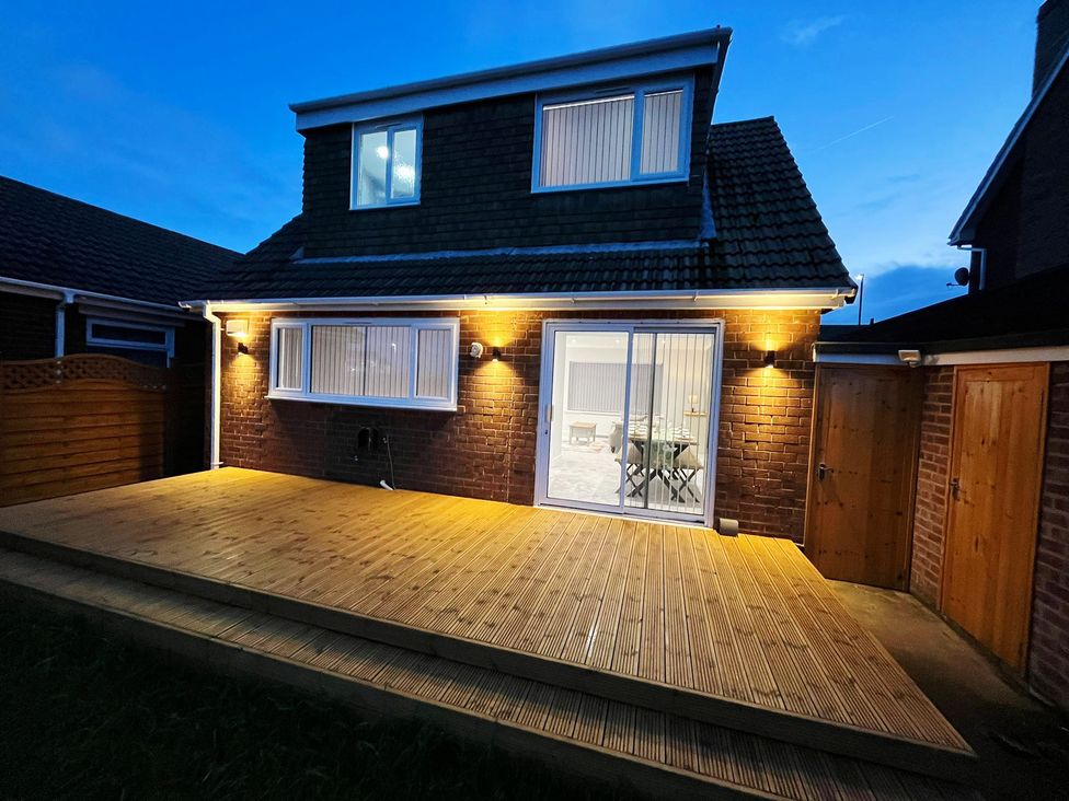 A house with decking and illuminated exterior at Sea View House in Marske-By-The-Sea