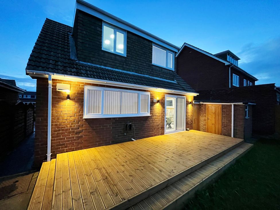 A house with a deck and outdoor lighting at Sea View House in Marske-By-The-Sea