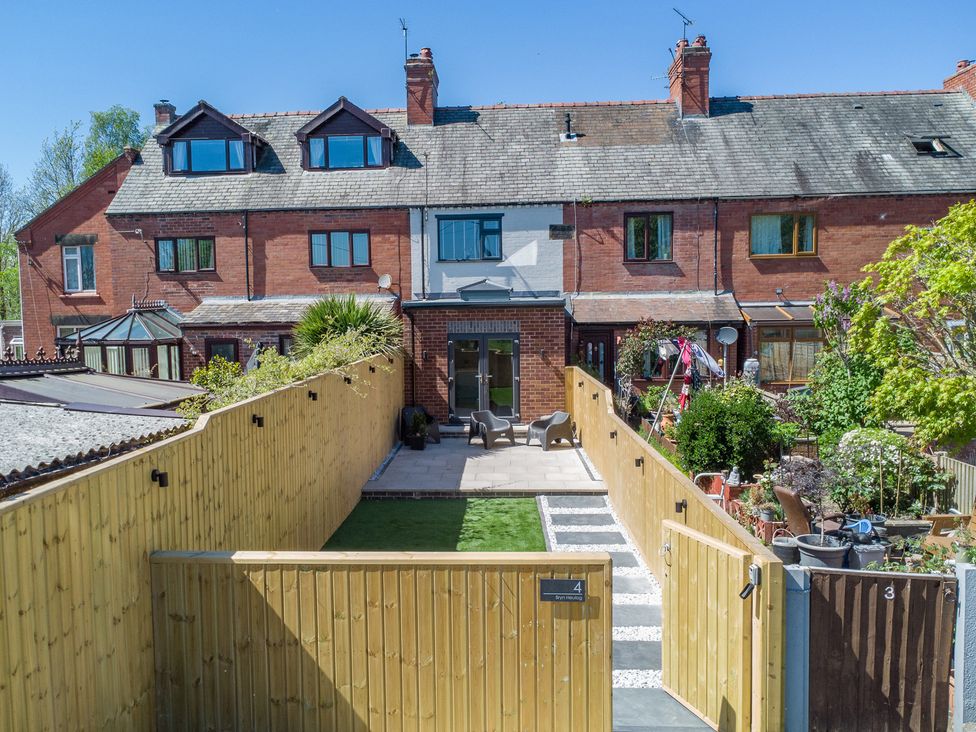 A garden with a pathway and seating area at 4 Bryn Heulog in Wrexham
