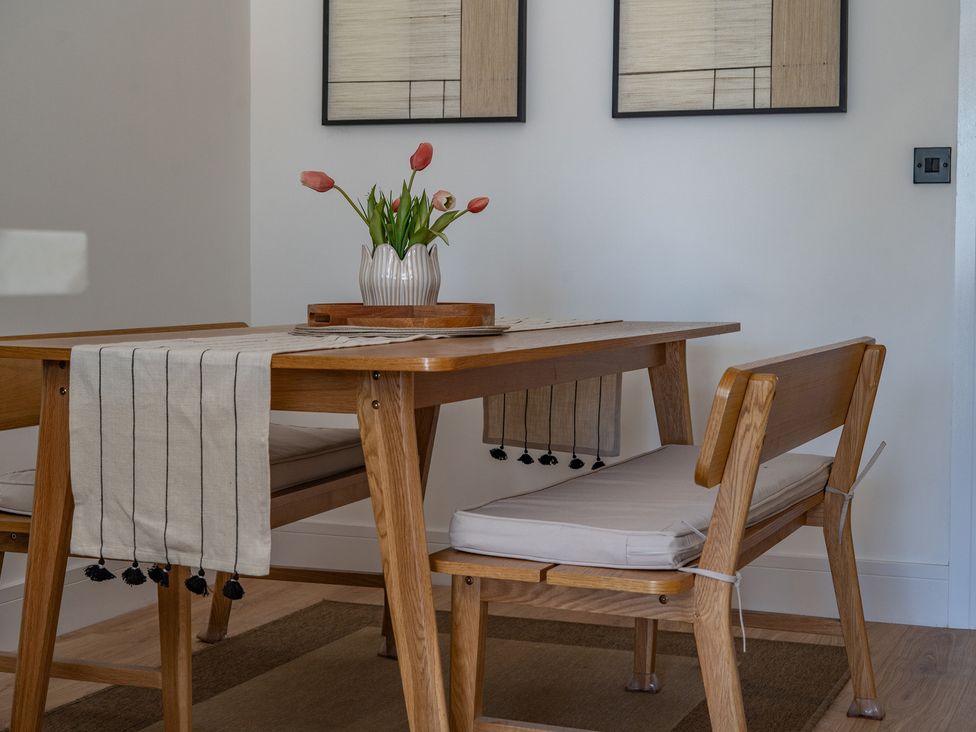 A dining room with a table and chairs at 4 Bryn Heulog in Wrexham
