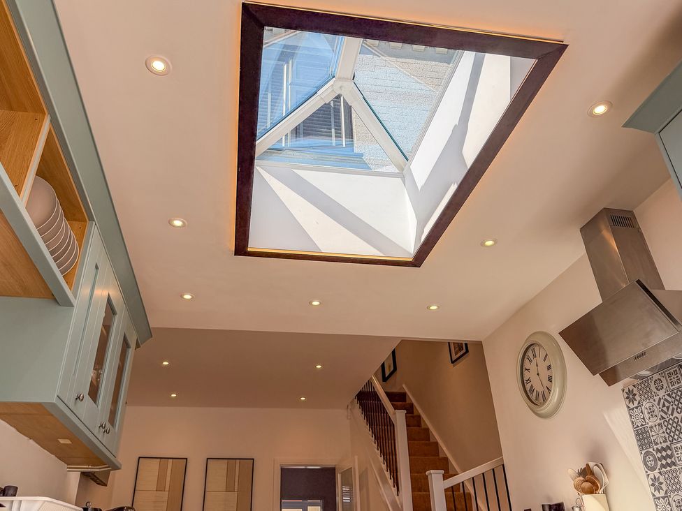 A kitchen with a skylight and cabinet at 4 Bryn Heulog in Wrexham