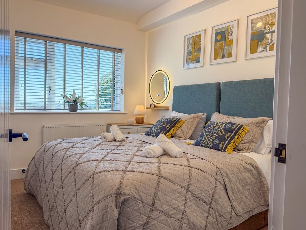 A bedroom with a bed and window at 4 Bryn Heulog in Wrexham
